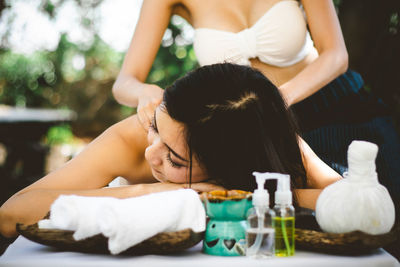 Midsection of woman sitting on table