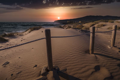 Scenic view of beach against sky during sunset