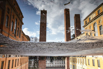 Low angle view of buildings in city against sky