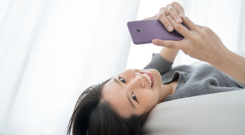 Portrait of young woman using mobile phone