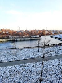 River by city against sky during winter