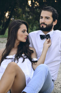 Young couple sitting on field