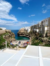 High angle view of buildings by sea against sky