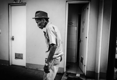 Man standing in corridor of building