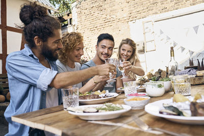 Friends having fun at a barbecue party, eating together