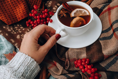 Midsection of woman holding coffee