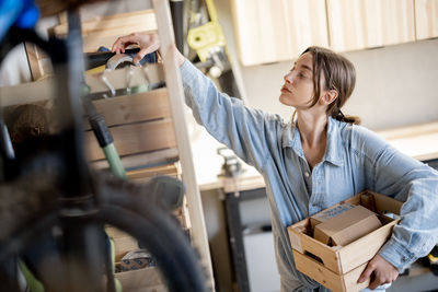 Woman looking at camera while sitting in store