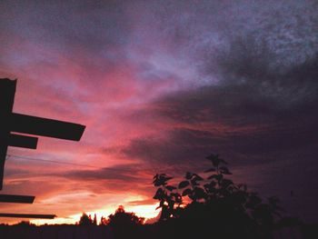 Silhouette of trees against cloudy sky
