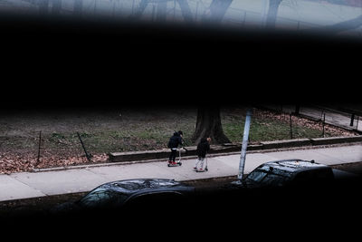 Silhouette people on road at night