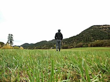 Woman standing on grassy field