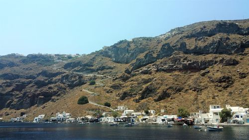Scenic view of sea and mountains against clear sky
