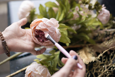 Close-up of woman painting fake fose