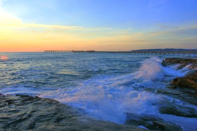 Scenic view of sea against sky at sunset