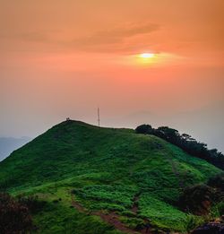 Scenic view of land against sky during sunset