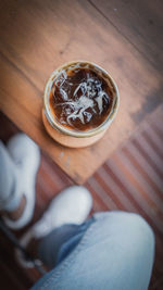 Low section of a man with coffee cup on table