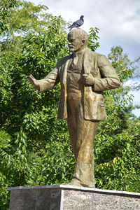 Low angle view of statue against trees in park