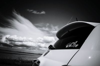 Low angle view of cropped car against sky