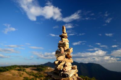 Stack of statue against sky