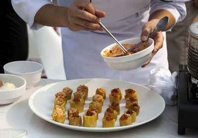 Midsection of chef slicing food