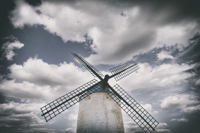 Low angle view of traditional windmill against sky