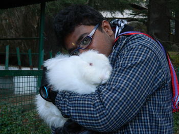 Man with cat in cage