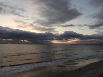 Scenic view of beach against sky during sunset