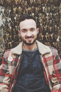 Portrait of smiling man against keys