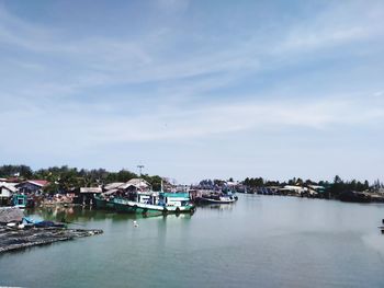 View of harbor and buildings against sky