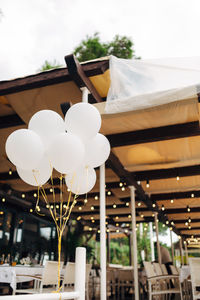 Low angle view of illuminated lighting equipment hanging from ceiling