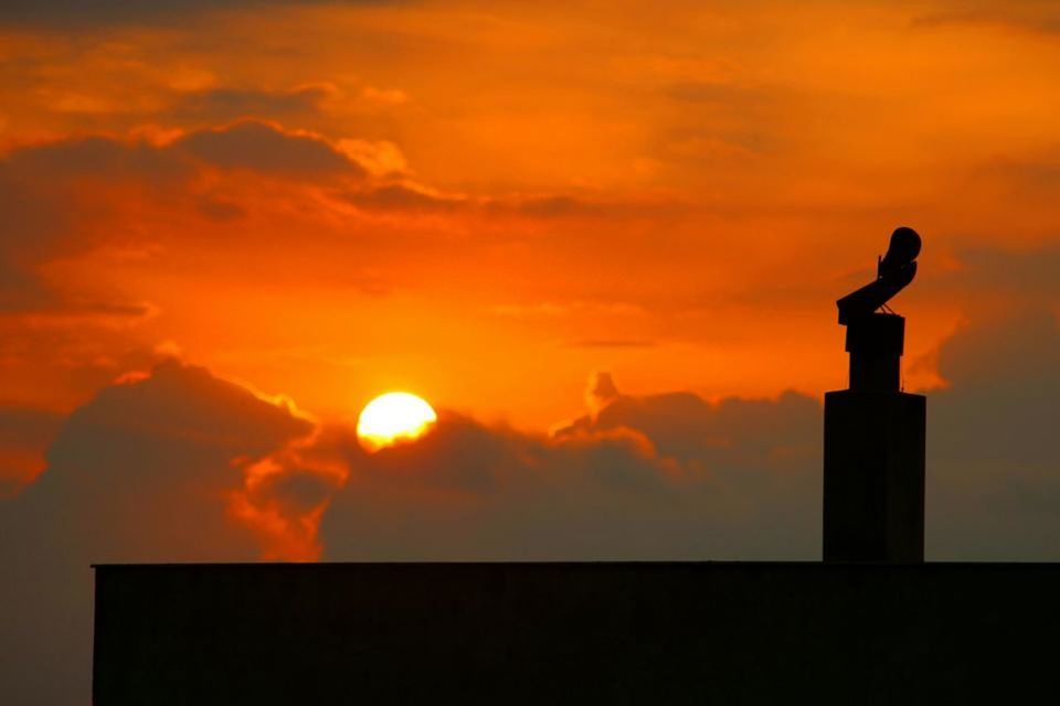 sunset, silhouette, sky, orange color, cloud - sky, statue, human representation, sculpture, art and craft, low angle view, art, cloud, beauty in nature, built structure, sun, creativity, nature, outdoors, cloudy