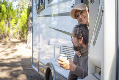 Couple sitting in camper van