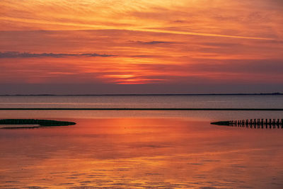 Scenic view of sea against romantic sky at sunset