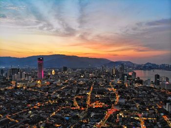 High angle view of illuminated buildings against sky during sunset