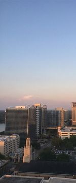 Cityscape against clear sky during sunset
