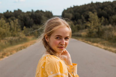 Portrait of smiling woman on road