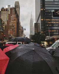 Close-up of umbrellas in city during rainy season