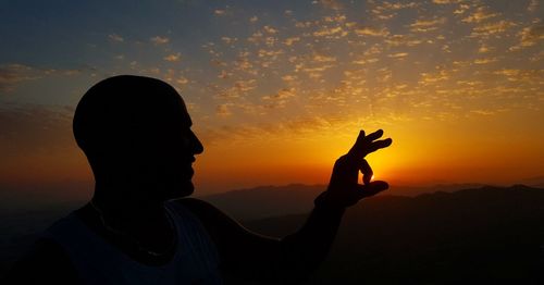 Full length portrait of silhouette man against sky during sunset