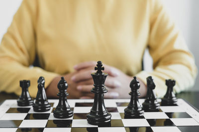 Midsection of woman playing on chess