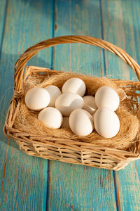 High angle view of eggs in basket on table