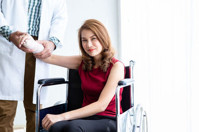 Beautiful young woman sitting in a room