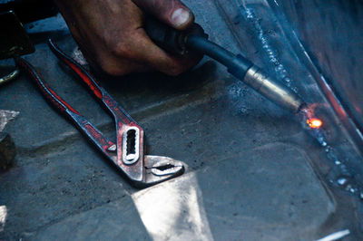 Close-up of hand welding metal