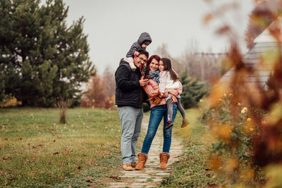 Full length of father with daughter against plants