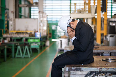 Side view of man working at construction site