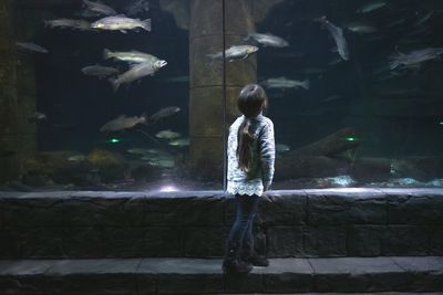 Full length of woman standing by railing