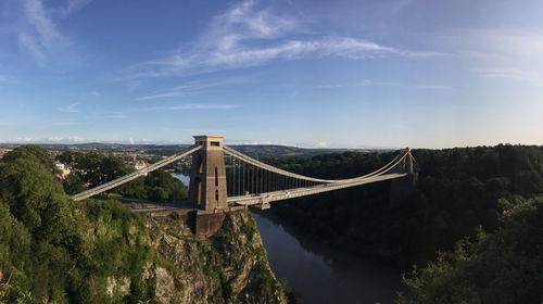 View of bridge over river against cloudy sky