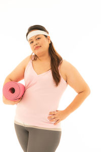 Young woman standing against white background