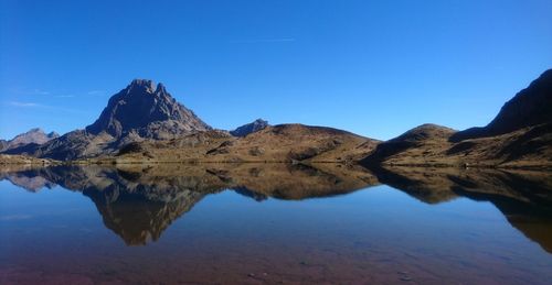 Scenic view of mountains against clear blue sky