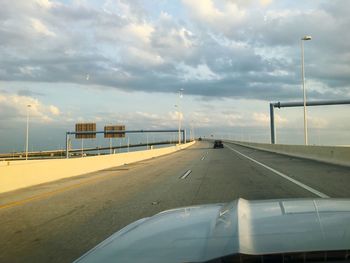 Cropped image of car on street against sky