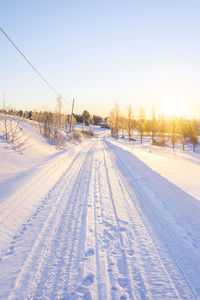 Snow covered landscape against clear sky