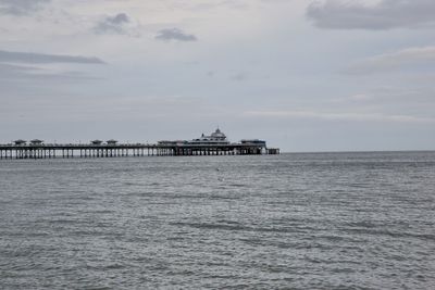 Pier over sea against sky